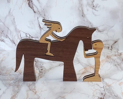 Layered wooden sculpture of horse with girl rider and boy reaching to horse's head - precision-cut walnut and plywood freestanding decor