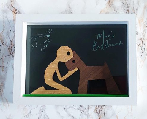 Man's Best Friend wooden shadow box featuring layered wooden figures of man hugging dog - handcrafted walnut and plywood display art
