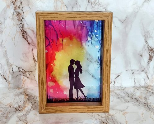 Romantic couple silhouette sublimated on clear acrylic with colorful sunset background creating stained glass window effect in 16x12cm frame