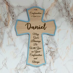 Personalised wooden cross with a blue acrylic border, engraved with the name Daniel, date, and a Confirmation blessing.